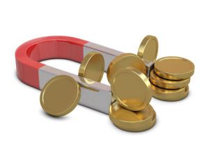 Magnet and golden coins isolated